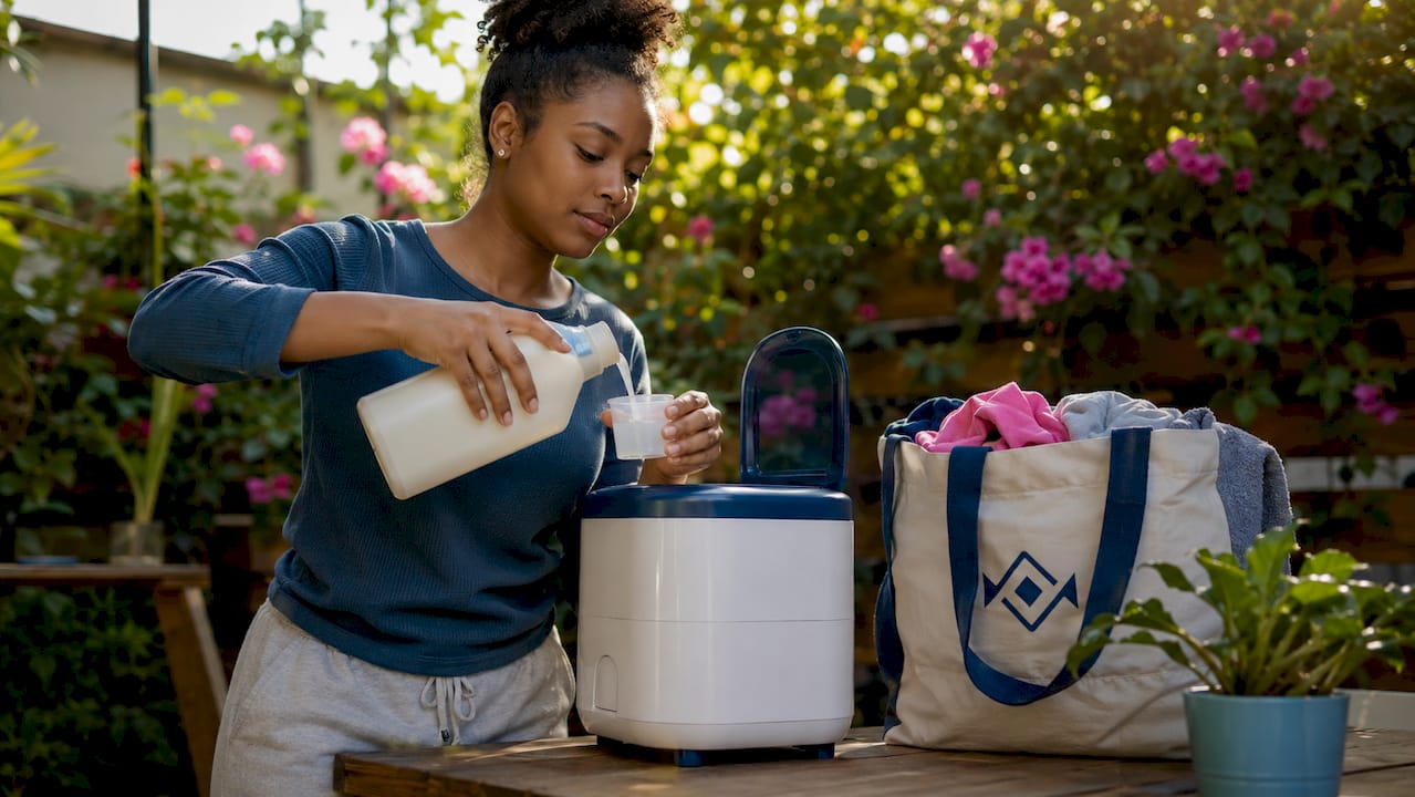 Woman loading detergent into washing machine