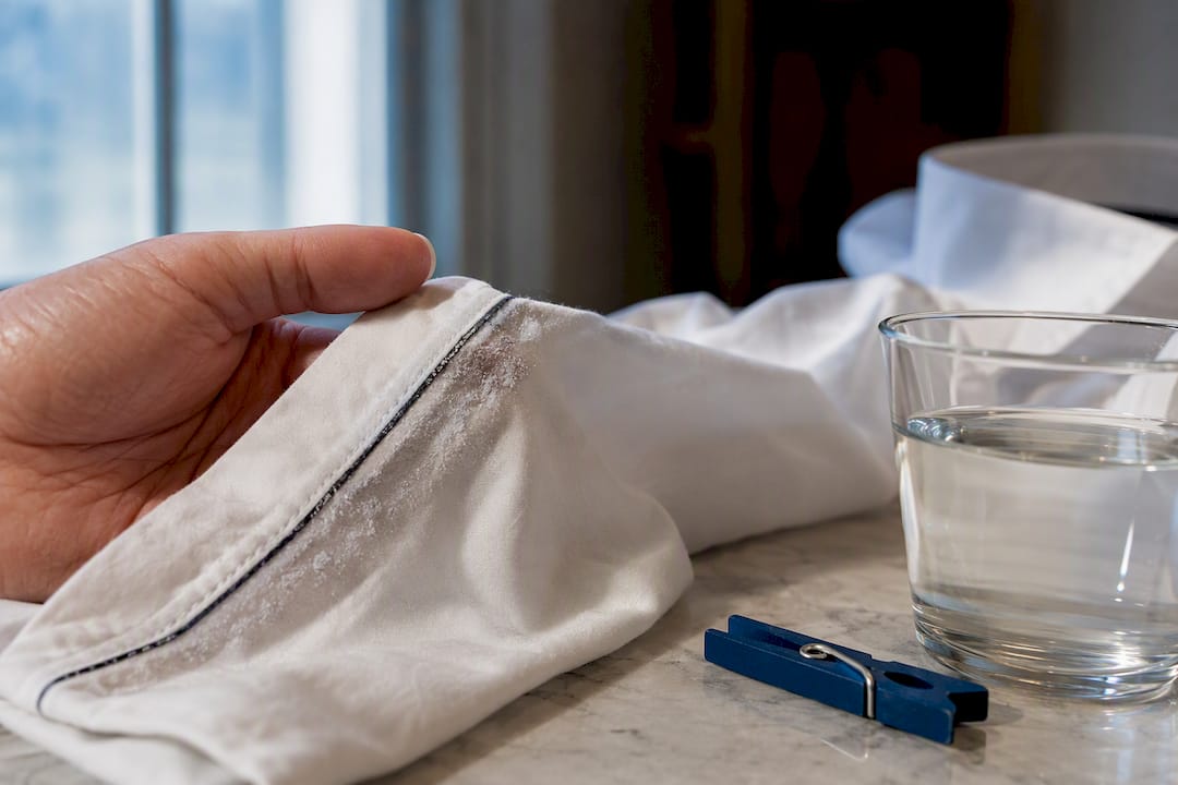 Detergent film visible on white shirt fabric