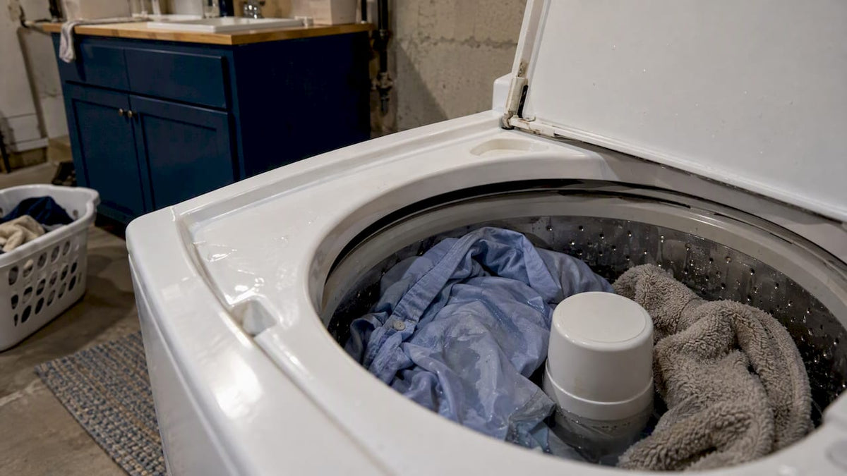 Damp clothes waiting inside an open washer
