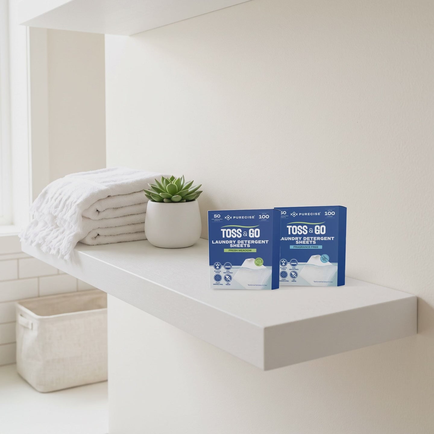 Purecise Toss & Go 50-sheet boxes, Fresh Meadow and Fragrance Free, on a bathroom shelf